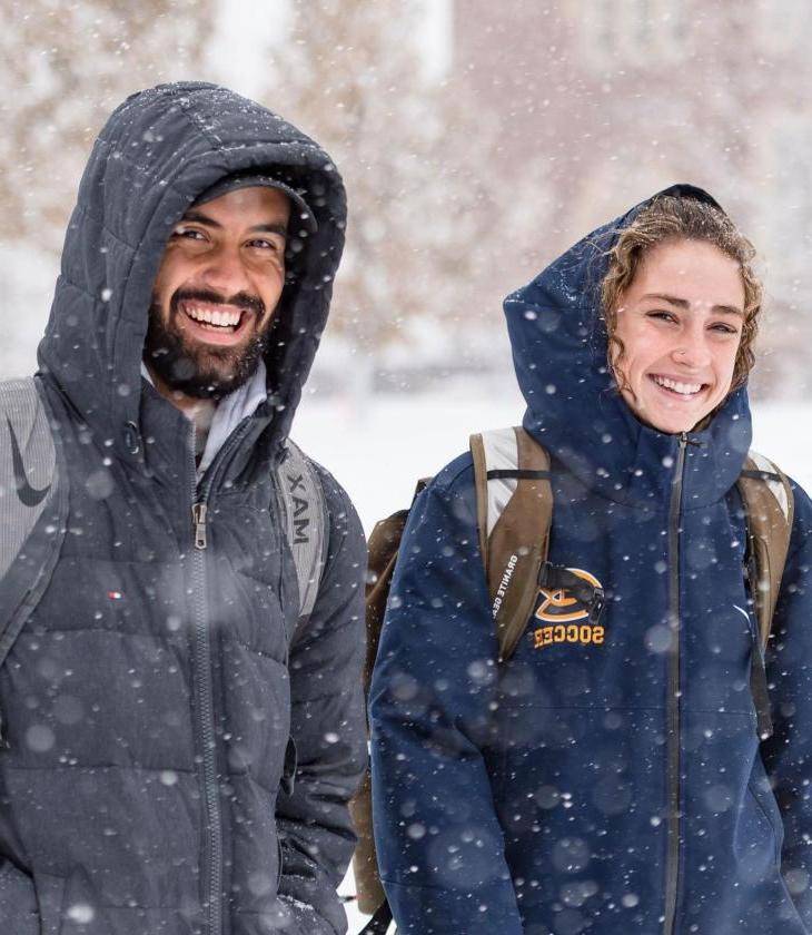 Two students walking in the snow